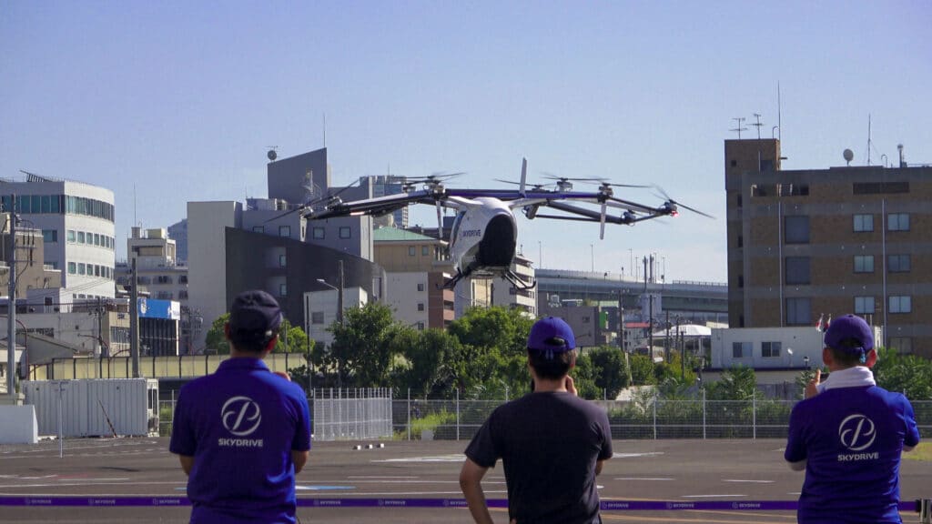 SkyDrive eVTOL aircraft charging at the 2025 Osaka Expo vertiport.